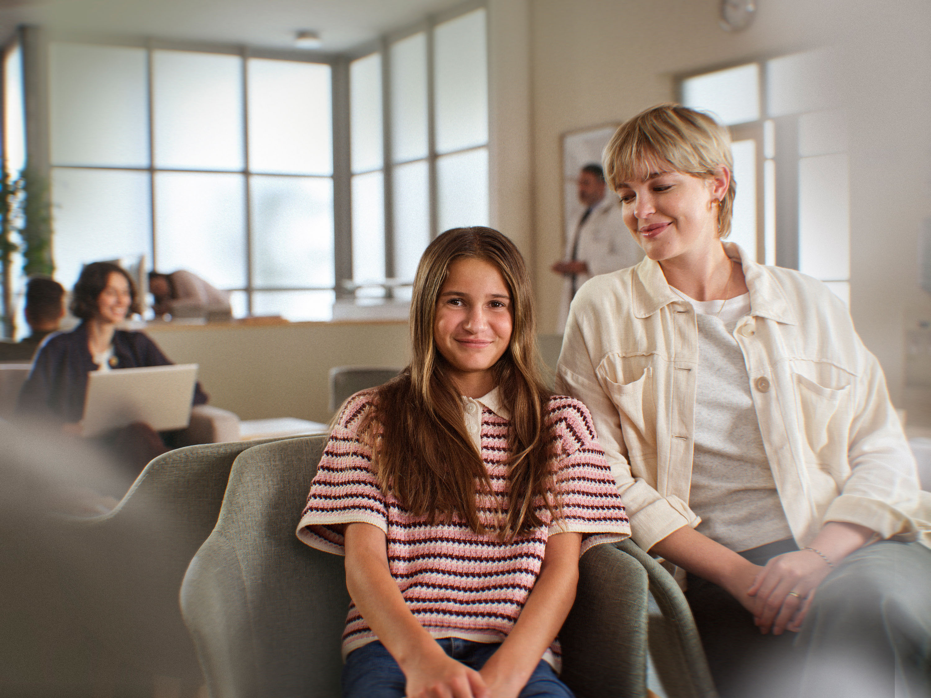 two people sitting in a waiting room